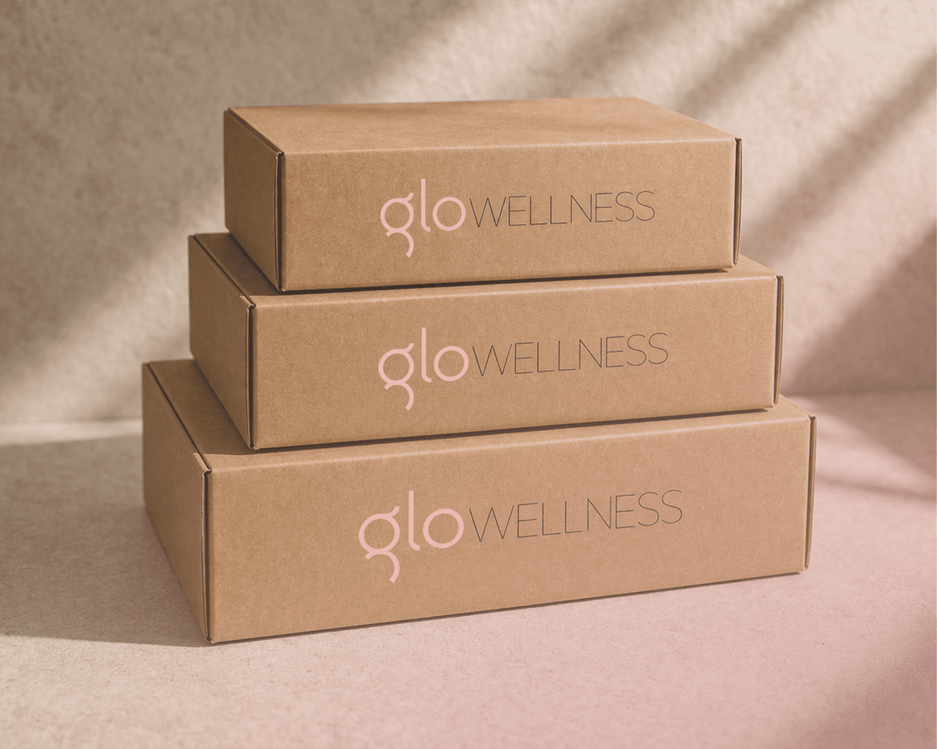 Stacked GloWellness kraft delivery boxes